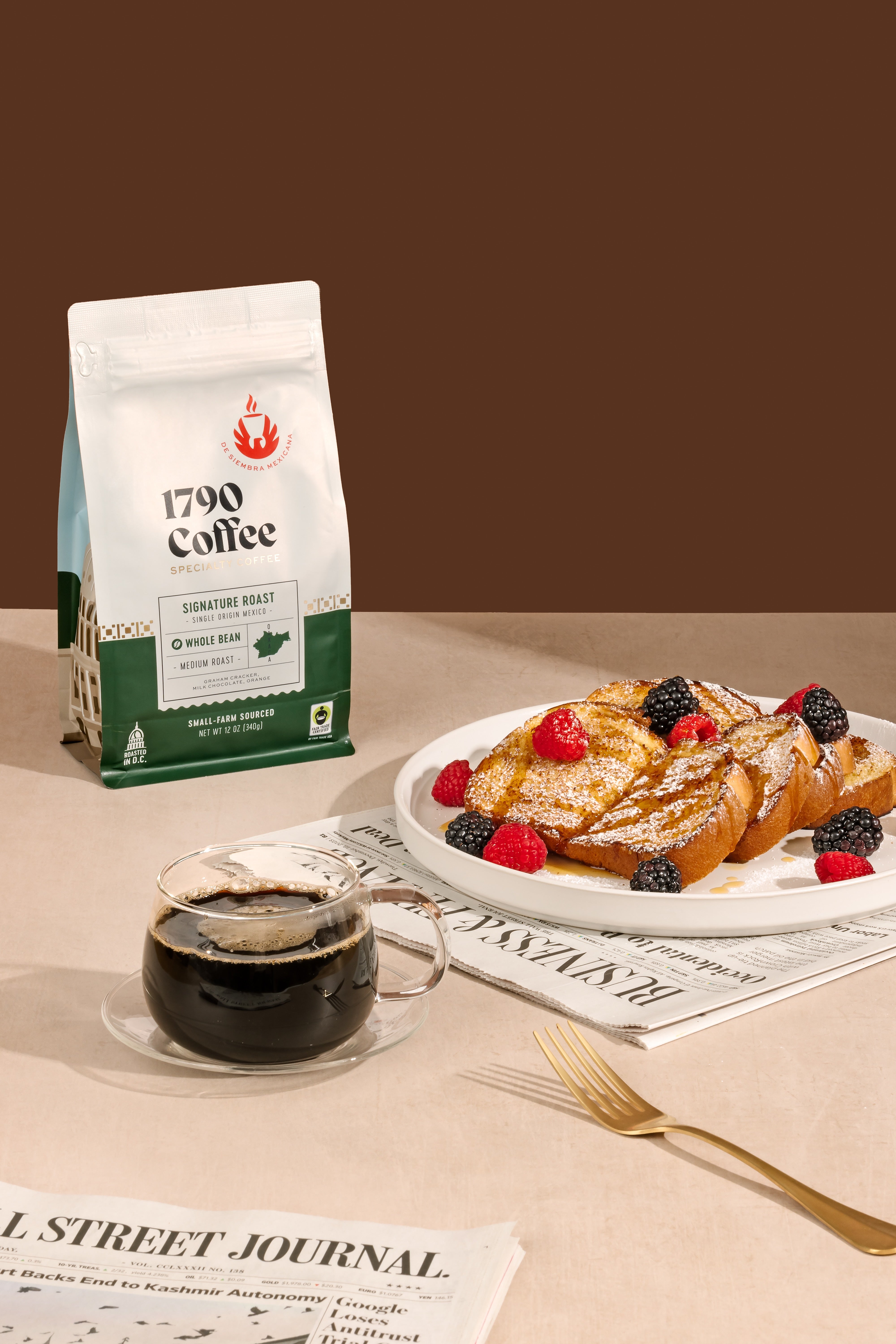 1790 Coffee bag with a plate of French toast and berries on a table.